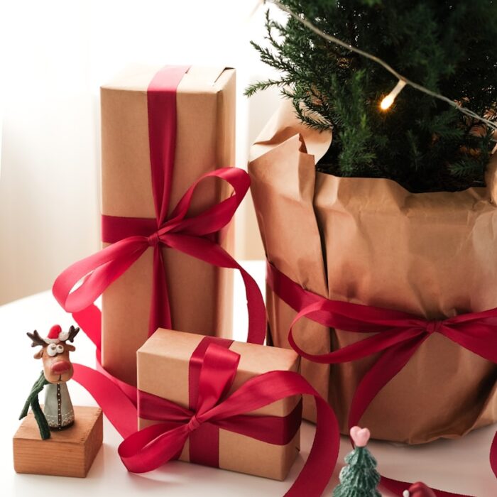 A christmas tree with presents wrapped in brown paper